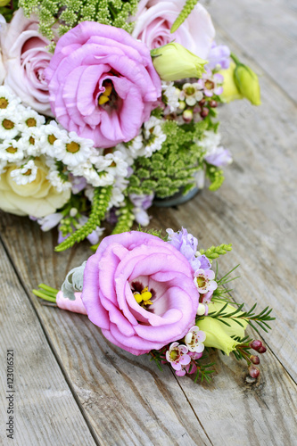 Wedding boutonniere with pink eustoma and chamelaucium flowers.