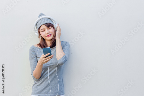 Asian woman listen to music with white headphone