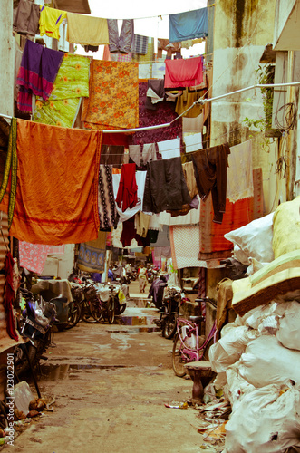 Colourful sheets hanging in alley