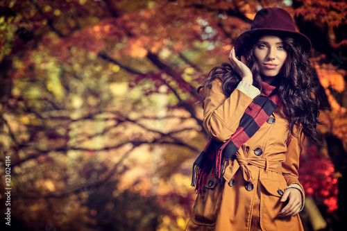 Fashion Woman in Hat and Scarf on Yellow Autumn Background in Su