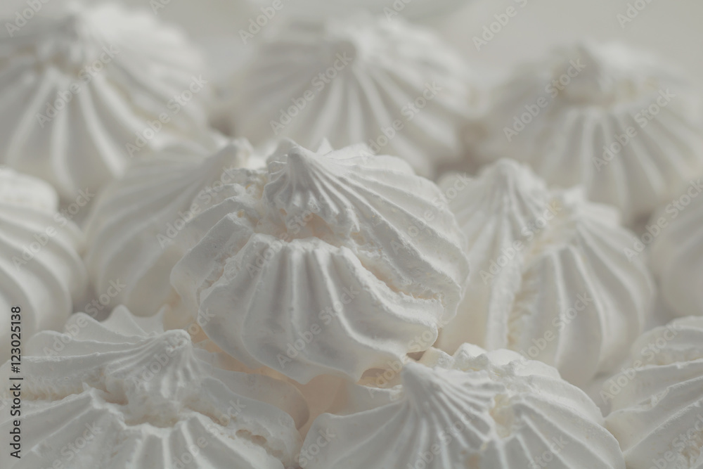 Close-up shot of white meringues on a white background