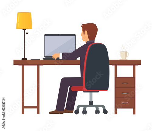 Businessman programmer works on a portable laptop computer at the office desk.