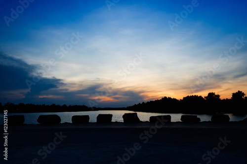 Beautiful blue sky sunset with stone at Tapee riverside Suratthani Thailand photo