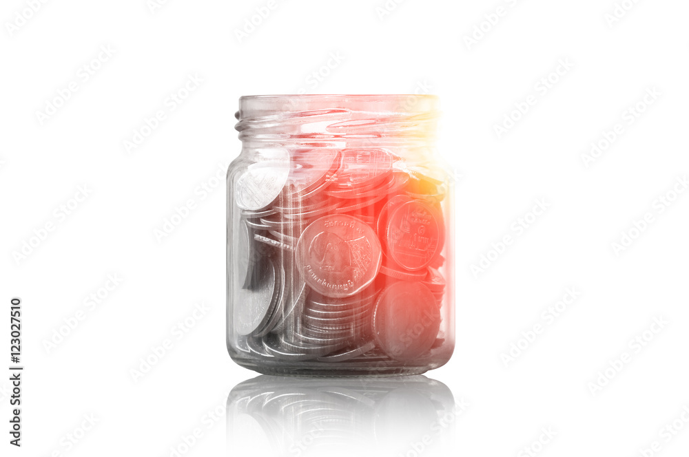 coins in a glass jar against ,savings coins - Investment And Interest Concept saving money concept, growing money on piggy bank. isolated on white background coins in a glass jar against ,savings coins - Investment And Interest Concept saving money concept, growing money on piggy bank. isolated on white background