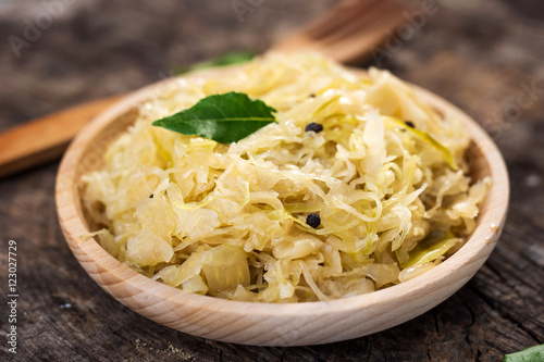 Steamed sauerkraut on old wooden background