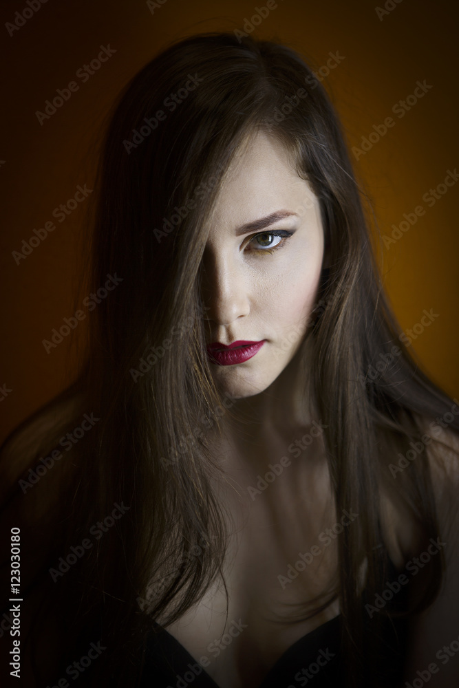 Portrait of a beautiful young girl on a dark background Portrait of a beautiful young girl on a dark background