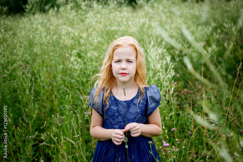 Portrait of beautiful little girl in the blue dress on the nature Portrait of beautiful little girl in the blue dress on the nature