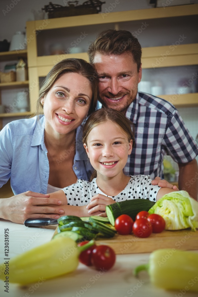 Portrait of happy family leaning on kitchen worktop Portrait of happy family leaning on kitchen worktop