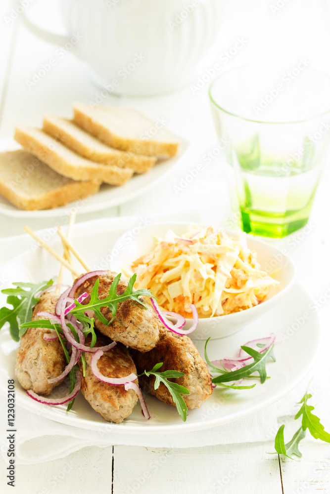 Kyufta kebab with salad close-up. Kyufta kebab with salad close-up.