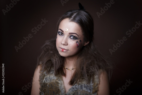 Fototapeta Naklejka Na Ścianę i Meble -  Portrait of a beautiful girl in the style of Indian America in a fur vest