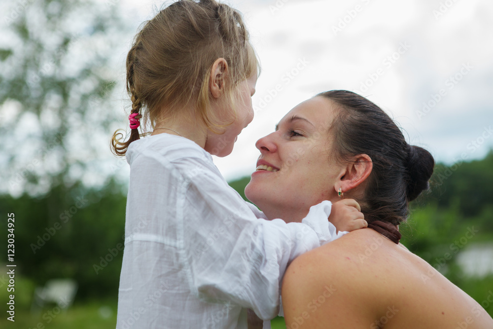 Portrait of mother and daughter outdoors forest river grass Portrait of mother and daughter outdoors forest river grass