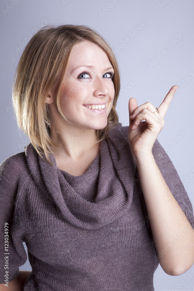 Portrait of a beautiful girl in a gray t-shirt with emotions in the Studio Portrait of a beautiful girl in a gray t-shirt with emotions in the Studio