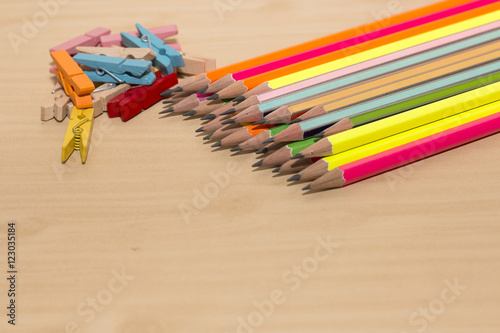 office desk with group of pencil and clothespin on wooden desk,colorful of pencil,colorful of clothespin on wooden desk 