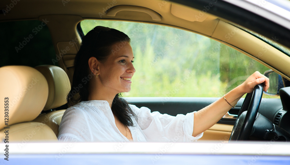 Beautiful Woman sitting inside the car in a white shirt