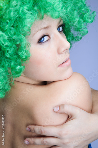 Portrait of a beautiful young girl in a wig