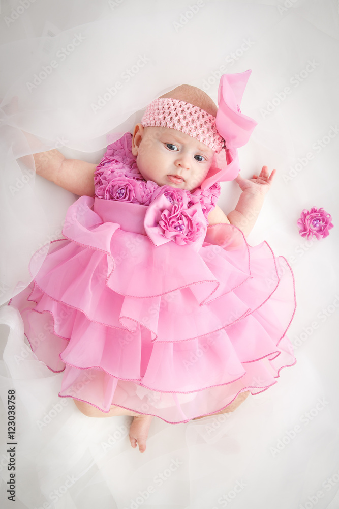 Portrait of a beautiful little baby girl in pink