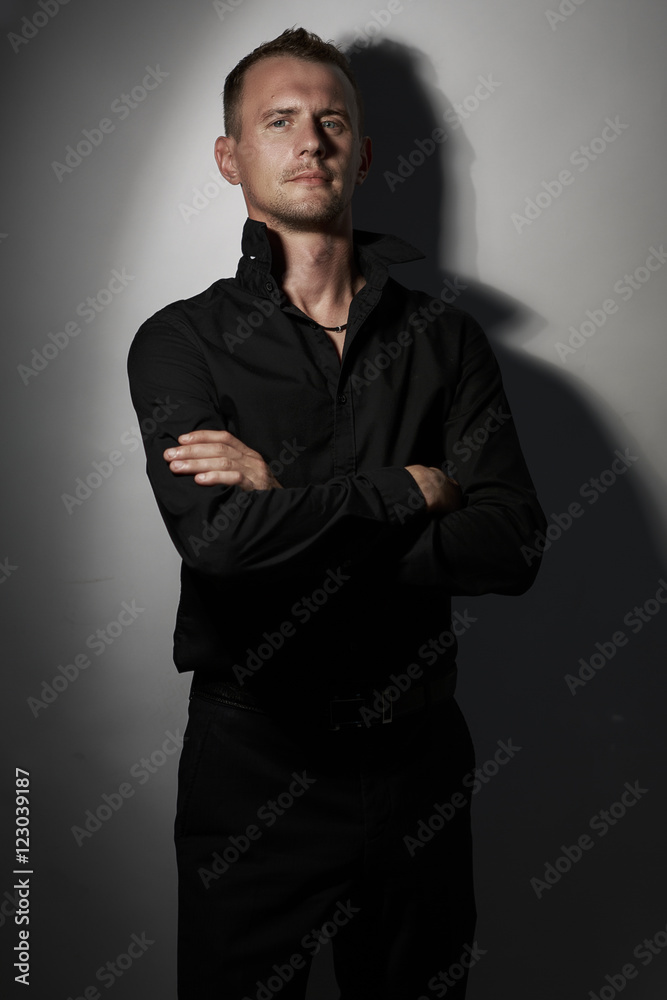 Portrait of handsome man in Studio wearing a black shirt Portrait of handsome man in Studio wearing a black shirt