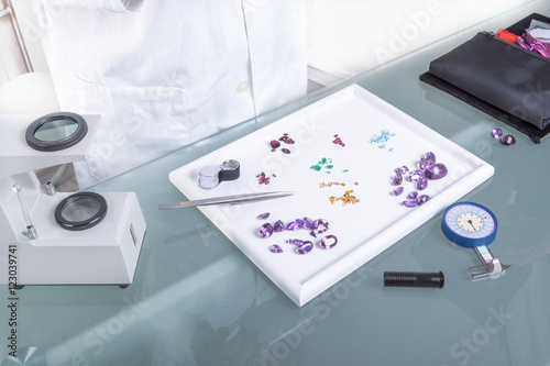 The Geomologist Table / Gems and tools on the table gemologist. photo