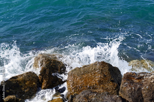 Rough waves clash against rocks
