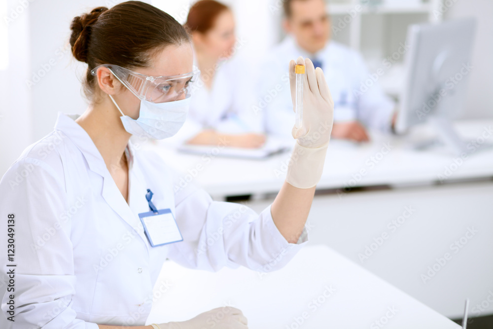 Scientific research team with clear solution in laboratory Scientific research team with clear solution in laboratory