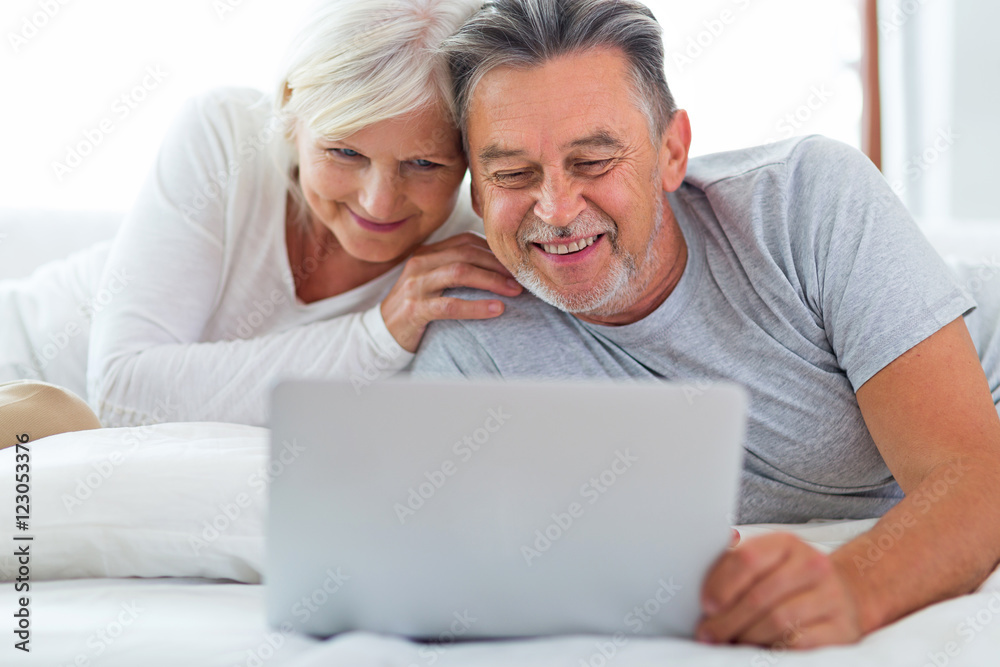 Senior couple using laptop
