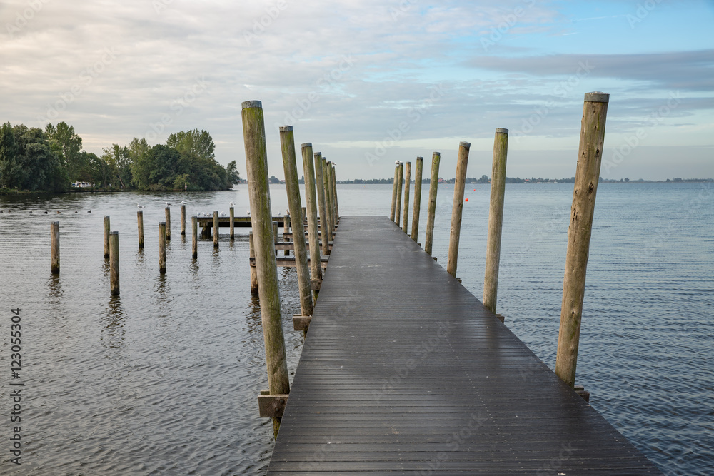 Wooden pier at Dutch lake in the early morning