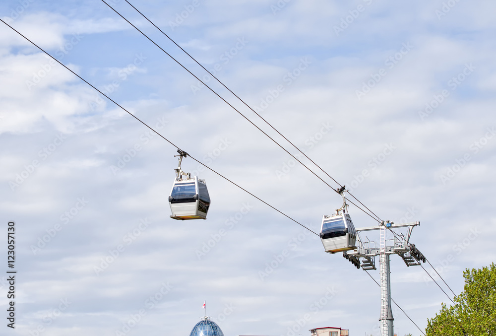 Two cabins cable car against the sky, Tbilisi Two cabins cable car against the sky, Tbilisi