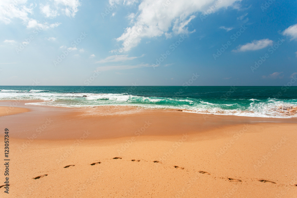 View of the ocean from the sandy beach. Footprints in the Sand. View of the ocean from the sandy beach. Footprints in the Sand.