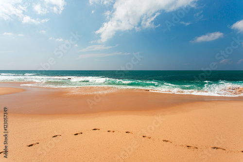 View of the ocean from the sandy beach. Footprints in the Sand. © michalsanca