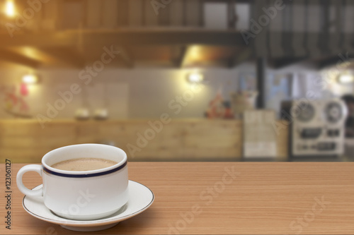 coffee on wooden table with abstract blur of counter bar