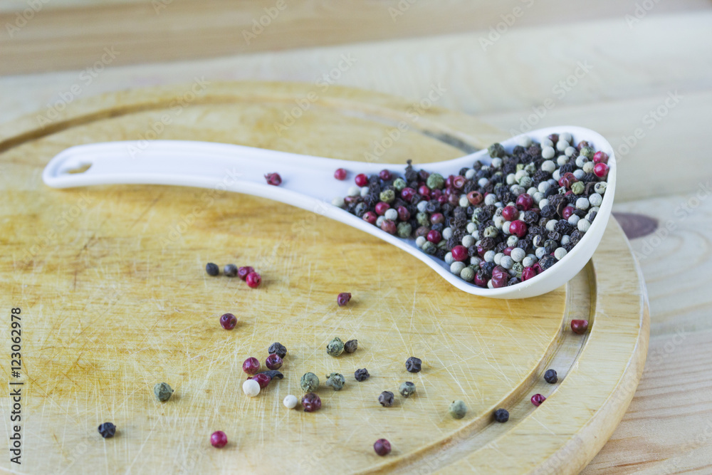 Black and white pepper on wood background Black and white pepper on wood background