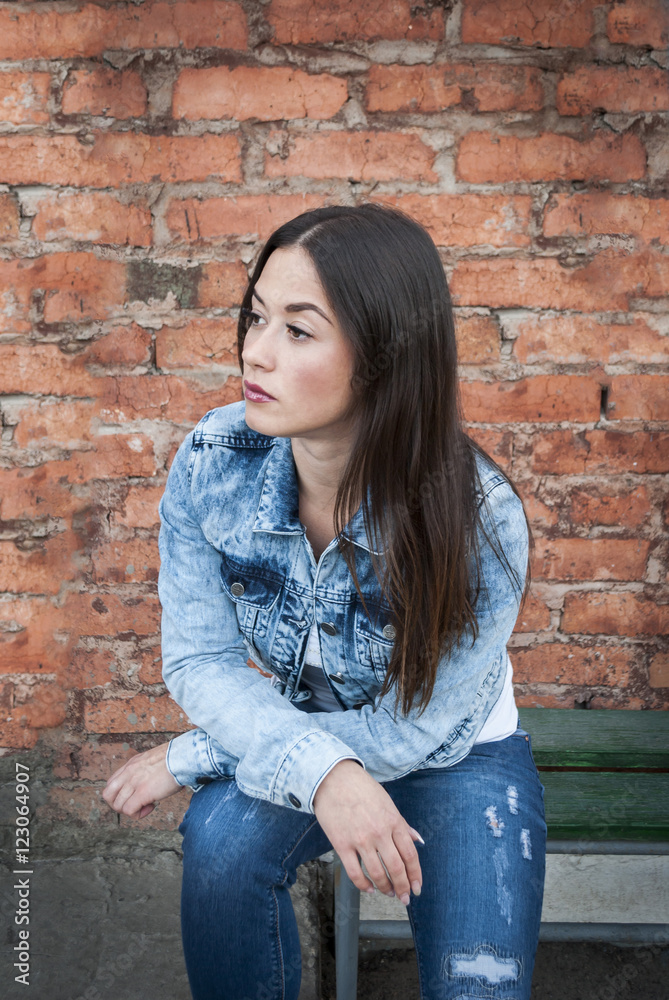 A portrait of beautiful woman with brick wall background A portrait of beautiful woman with brick wall background