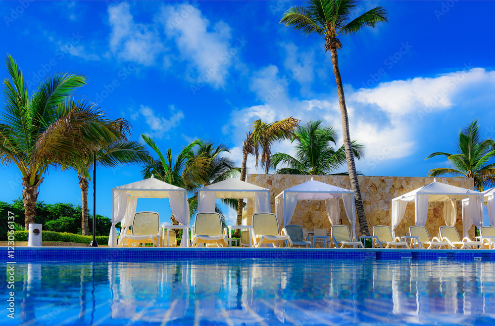 a swimming pool with sun loungers a swimming pool with sun loungers