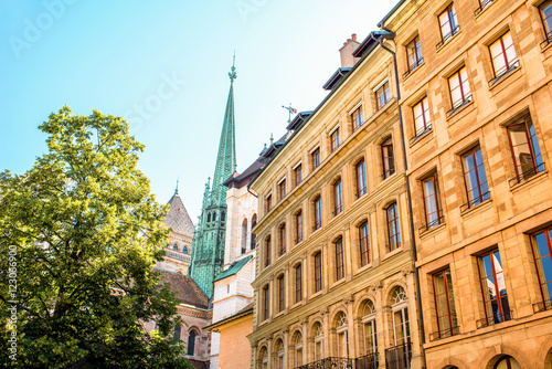 Street view with old buildings and Saint Pierre church's spire in the old town of Geneva city in Switzerland