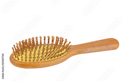 wooden bamboo comb for hair care on white