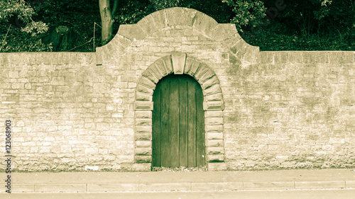 Canvas-taulu Old Wooden Door with Stone Round Arch