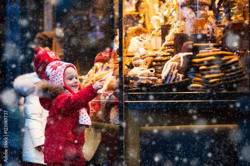 Kids looking at candy and pastry on Christmas market photo