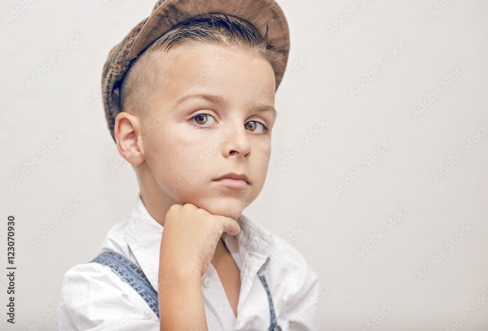 children's portrait, the boy model posing for a photo, beautiful boy has his hand under the chin,black and white photography children's portrait, the boy model posing for a photo, beautiful boy has his hand under the chin,black and white photography