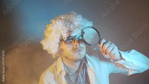 funny scientist, like Einstein with a magnifying glass photo