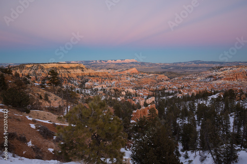 Sunset over canyon slopes covered in snow, Bryce Canyon National