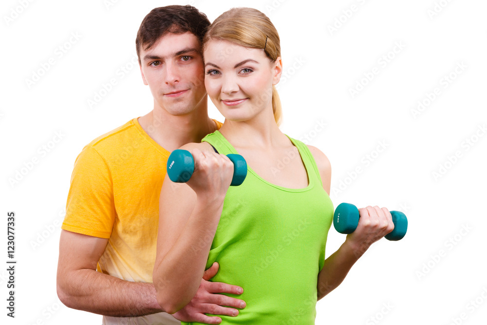 Couple exercising with dumbbells lifting weights Couple exercising with dumbbells lifting weights