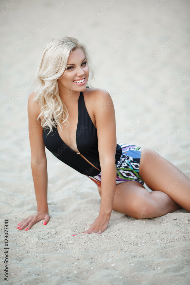 Fototapeta premium Sexy bikini model at sand beach
