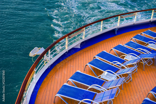 Blue sunbeds on a deck of a cruise ship