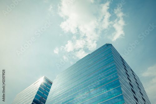 Glass office building with blue sky