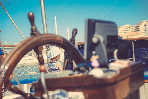 Closeup view on steering wheel of the ship, background outdoors