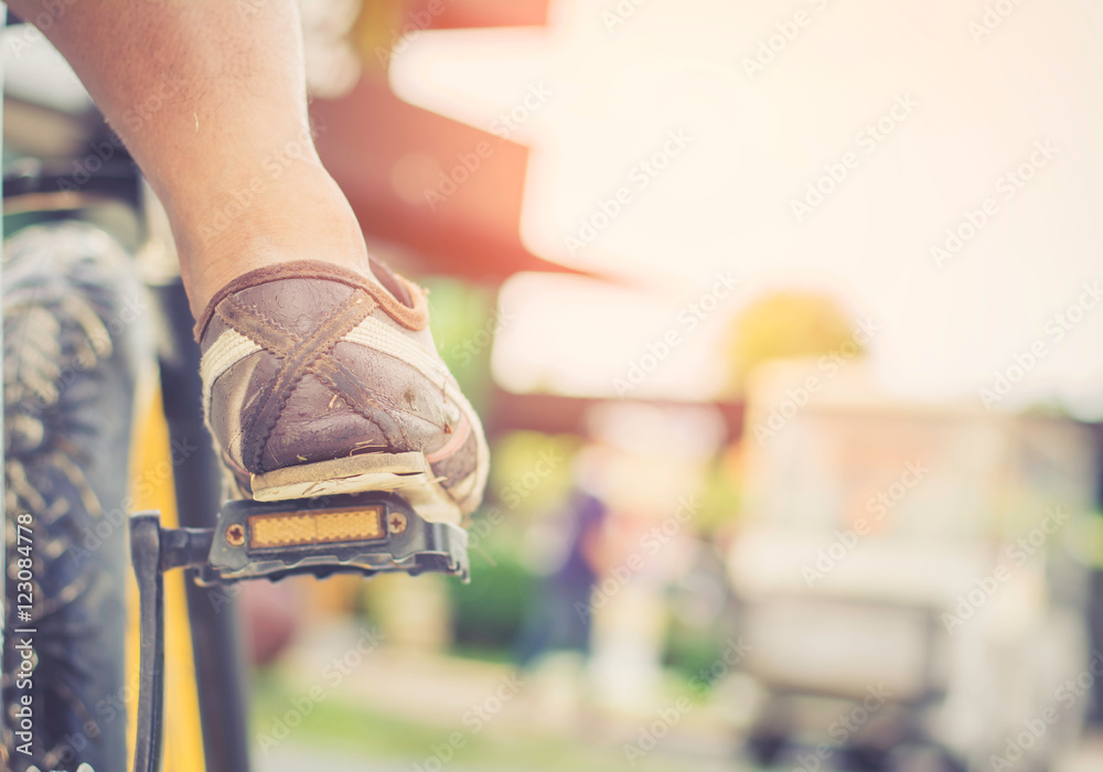 Fototapeta premium Selective focus foot on pedal of bicycle. active summer