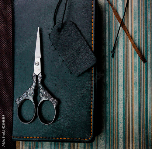 still life. vintage. notebook, scissors on the old paper. close-up