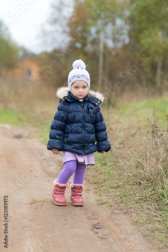 little girl on a dirt road