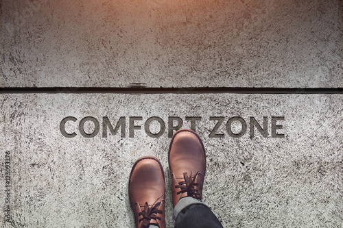 Comfort Zone Concept, Male with Leather Shoes Steps over a word photo