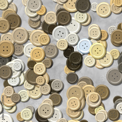 a lot of natural beige multi colored vintage clothing plastic buttons randomly scattered on the gray background - top view